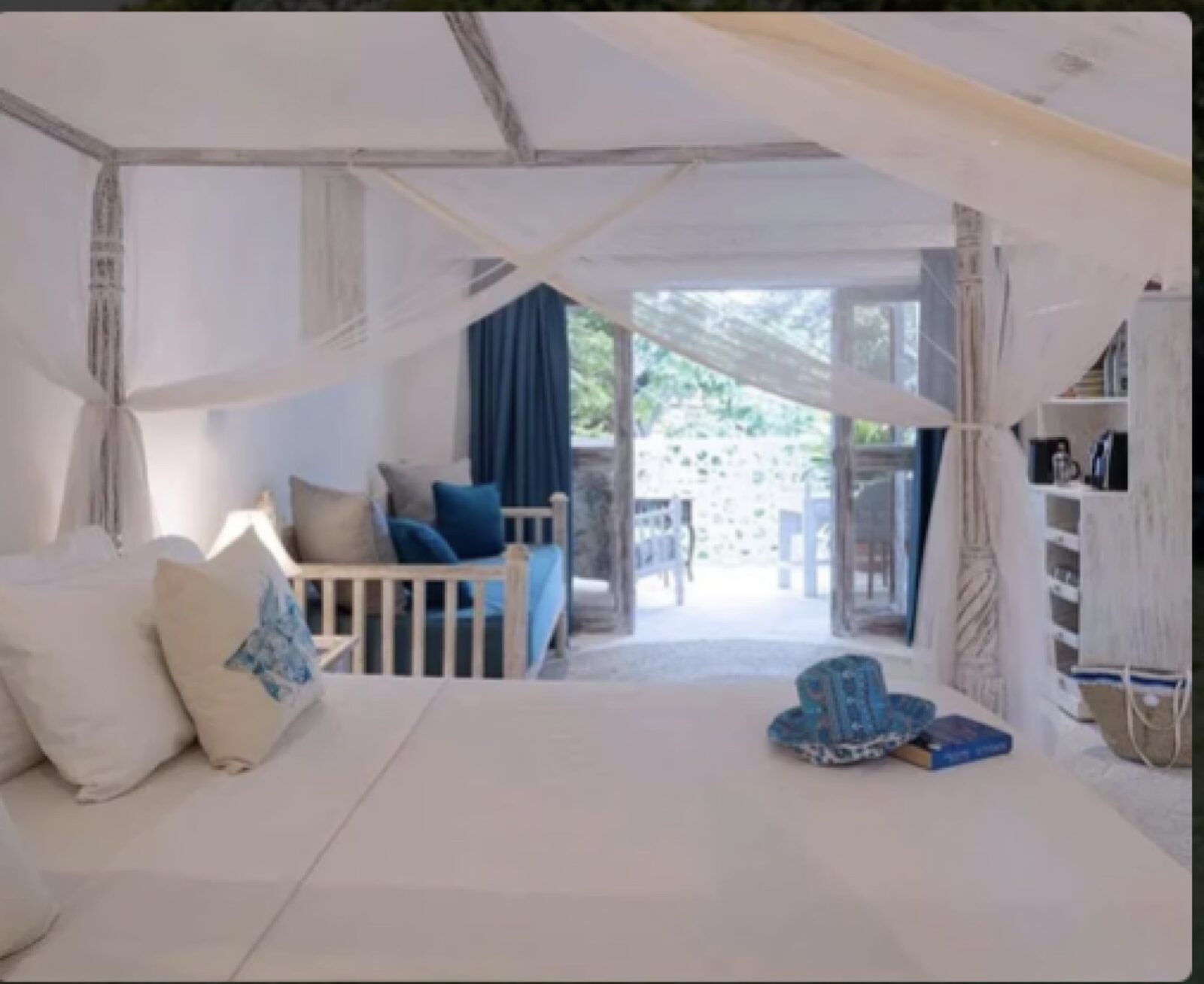 An airy white bedroom at the Diani Beach villa